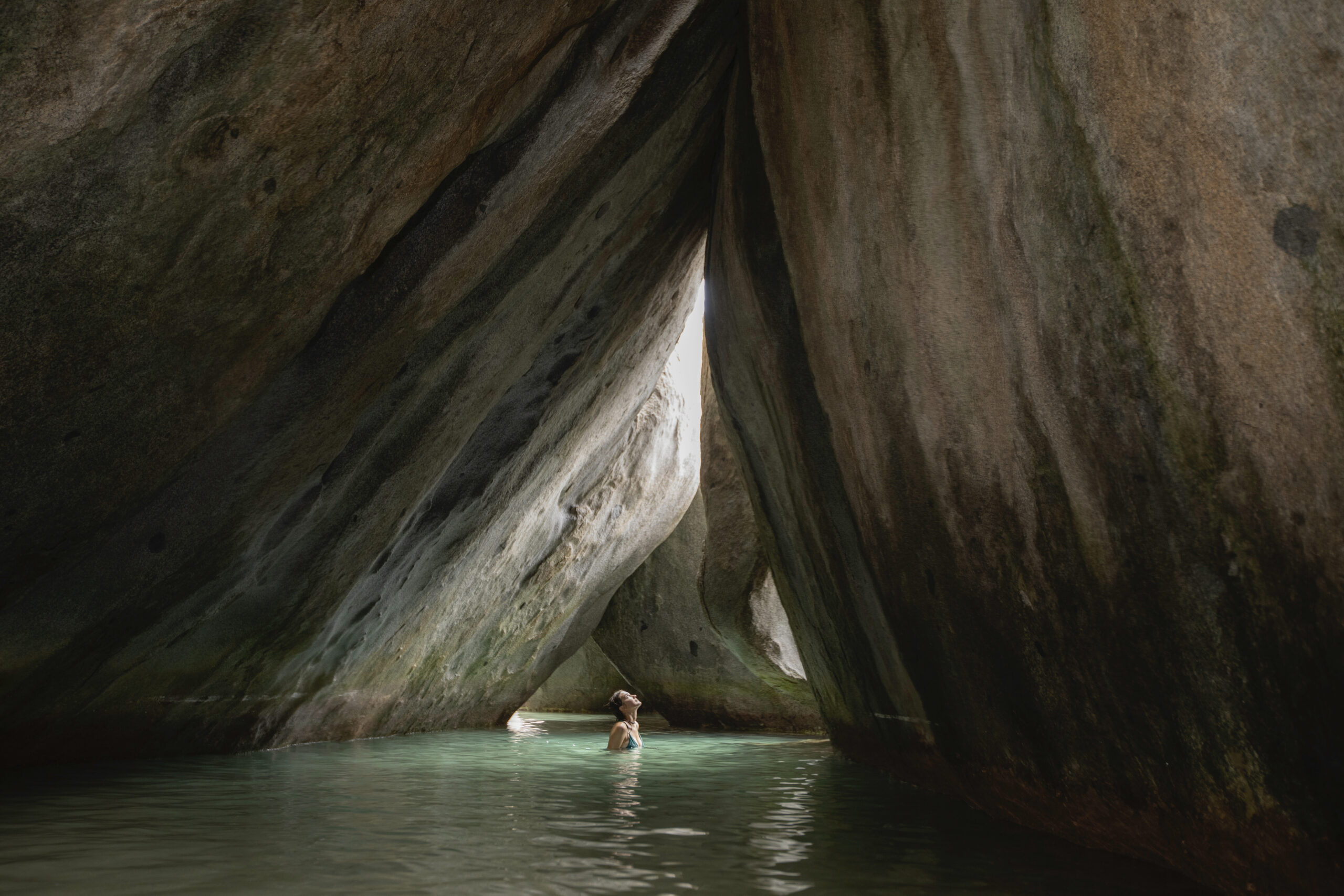 A woman exploring a flooded grotto at Virgin Gorda, British Virgin Islands